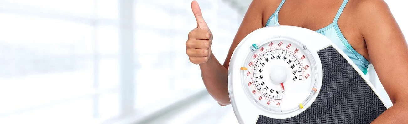 Person Holding Scale with Thumbs Up