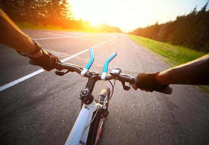 Riding Bicycle on Street into Sun